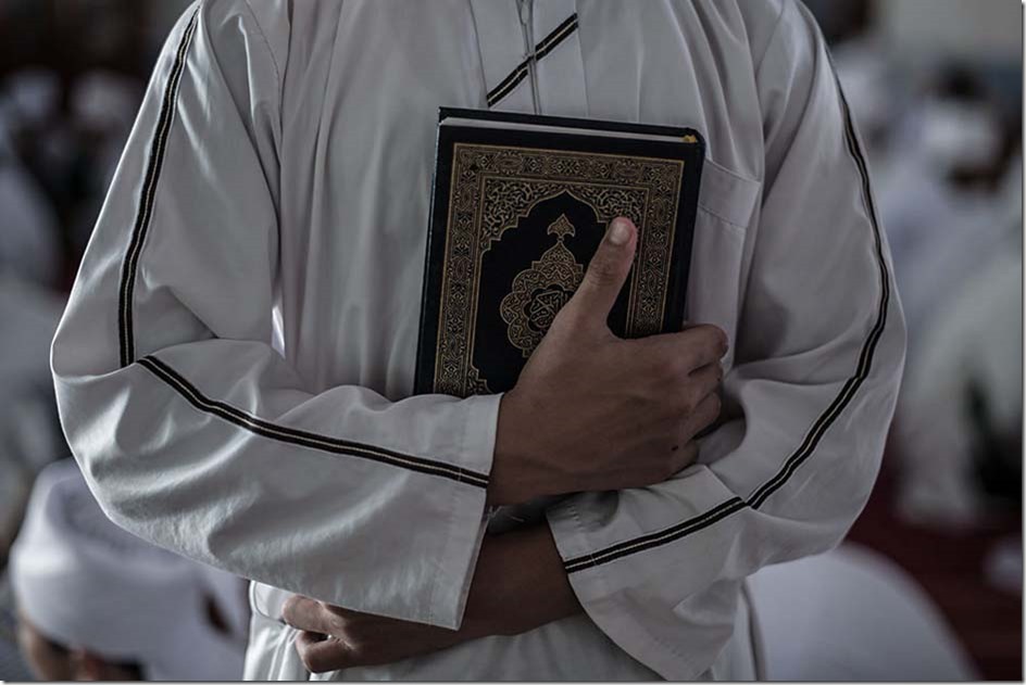 A Malaysian religious student holds the Koran at school during the Muslim holy fasting month of Ramadan in Hulu Langat, near Kuala Lumpur on June 30, 2014. Islam's holy month of Ramadan is celebrated by Muslims worldwide marked by fasting, abstaining from foods, sex and smoking from dawn to dusk for soul cleansing and strengthening the spiritual bond between them and the Almighty. AFP PHOTO / MOHD RASFAN 